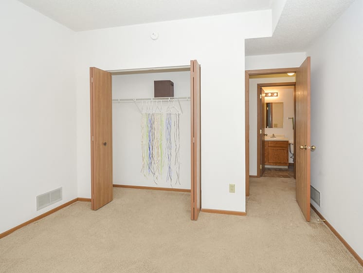 Bedroom with Accordion Style Closet Doors